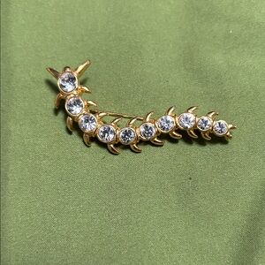Chic gold Centipede brooch adorned with shimmering rhinestone accents.